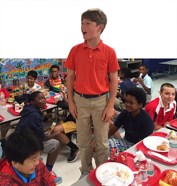 Sixth-grader Zachary Michael recites Theodore Roosevelts’ “The Man in the Arena” during lunch.